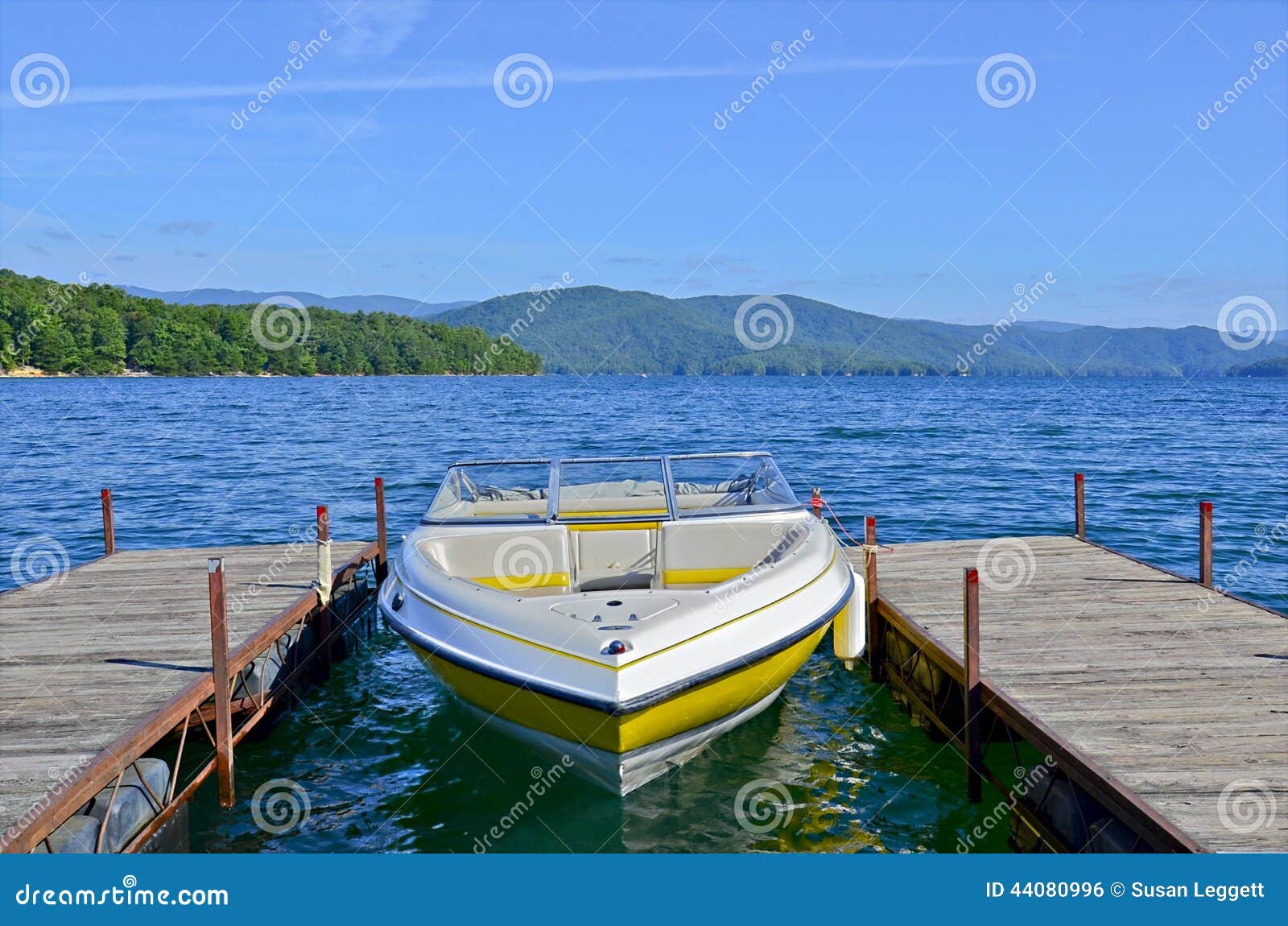 yellow boat at dock on a lake