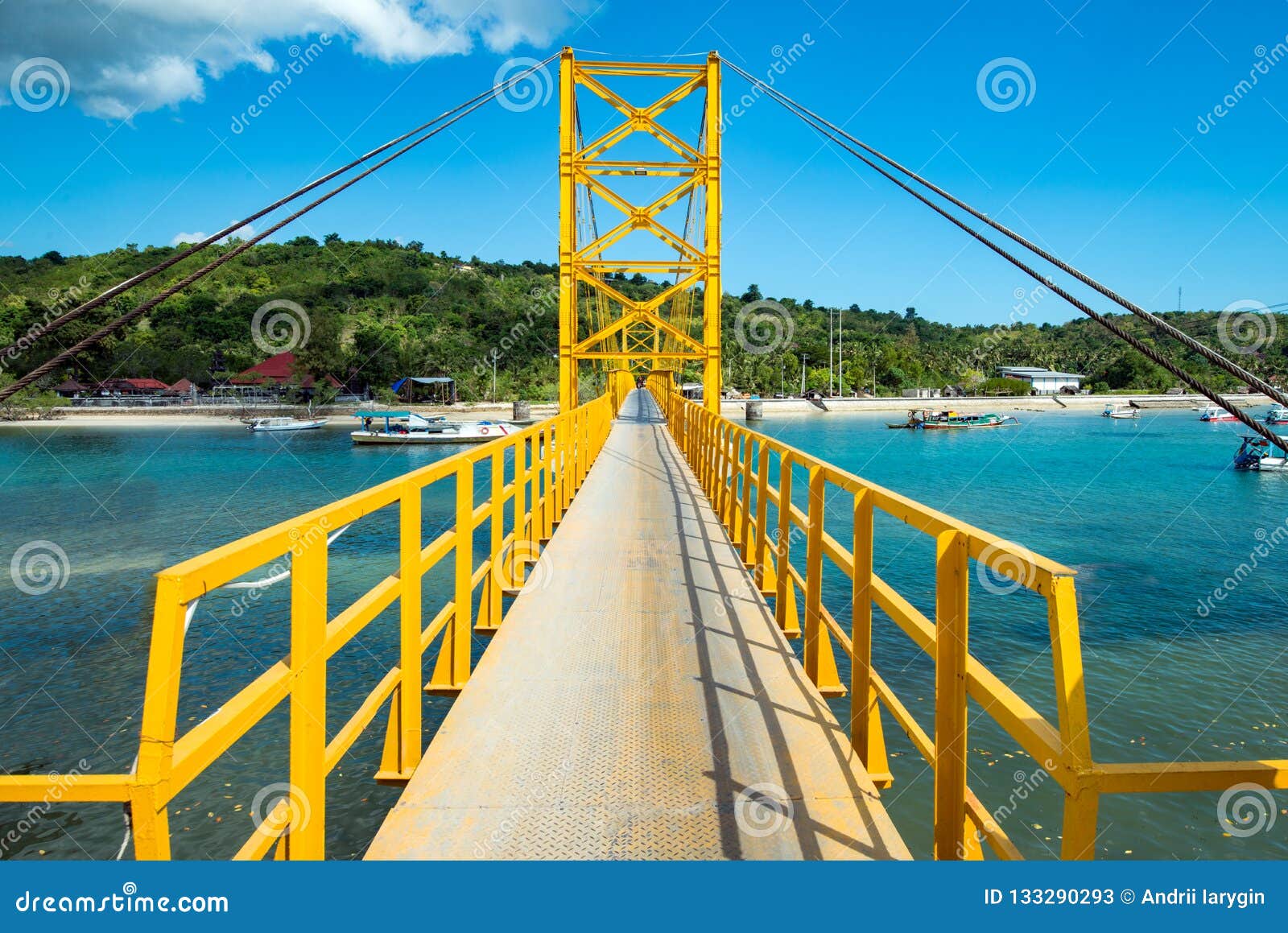 yellow bridge between the islands of nusa cheningan and nusa lembongan