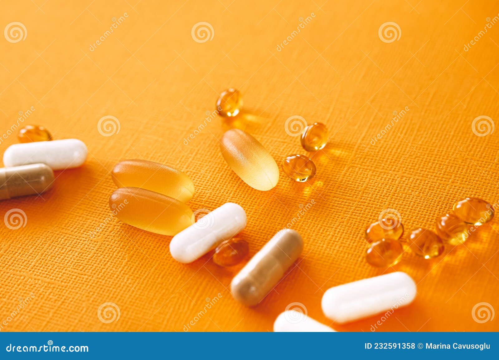 yellow capsules of nutraceuticals in spoon. pills and meds.