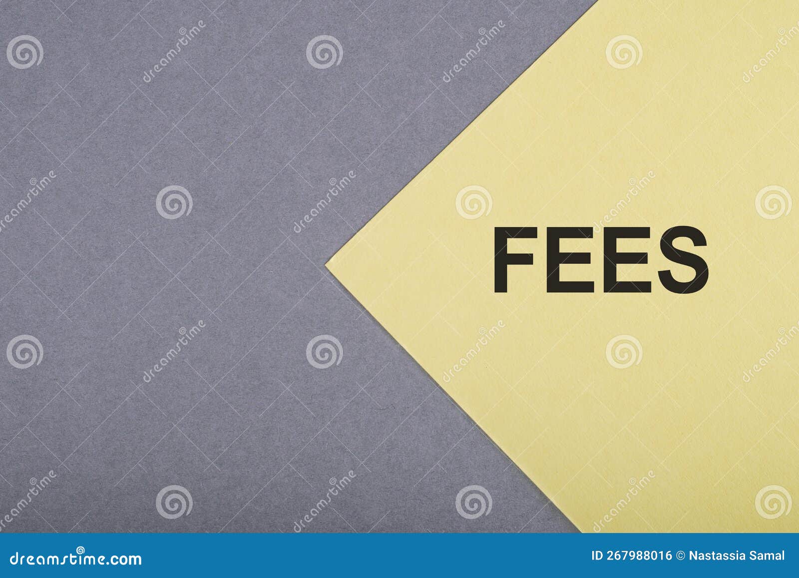 A Yellow Card with the Text FEES on the Gray Desk Stock Photo Image