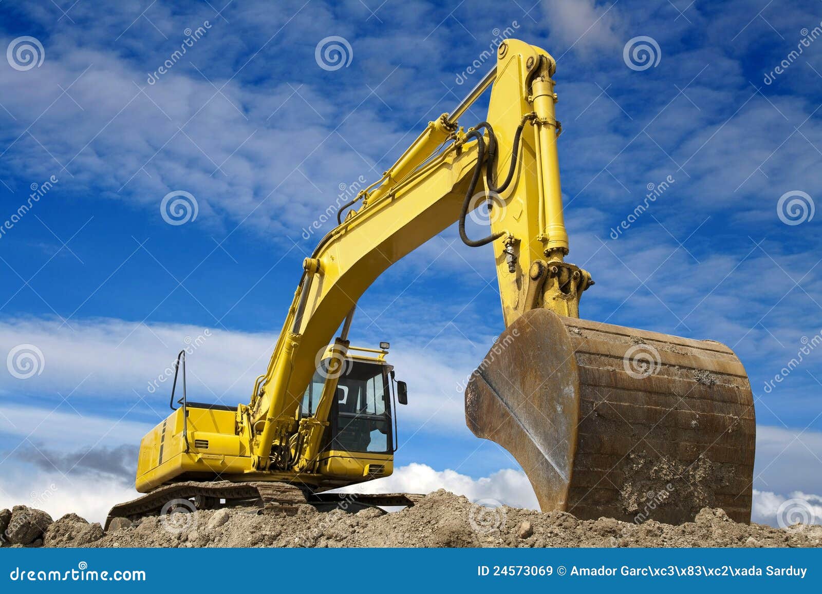 Yellow excavator levels its bucket of sand, earth, clay, Stock Photo,  Picture And Low Budget Royalty Free Image. Pic. ESY-058997993