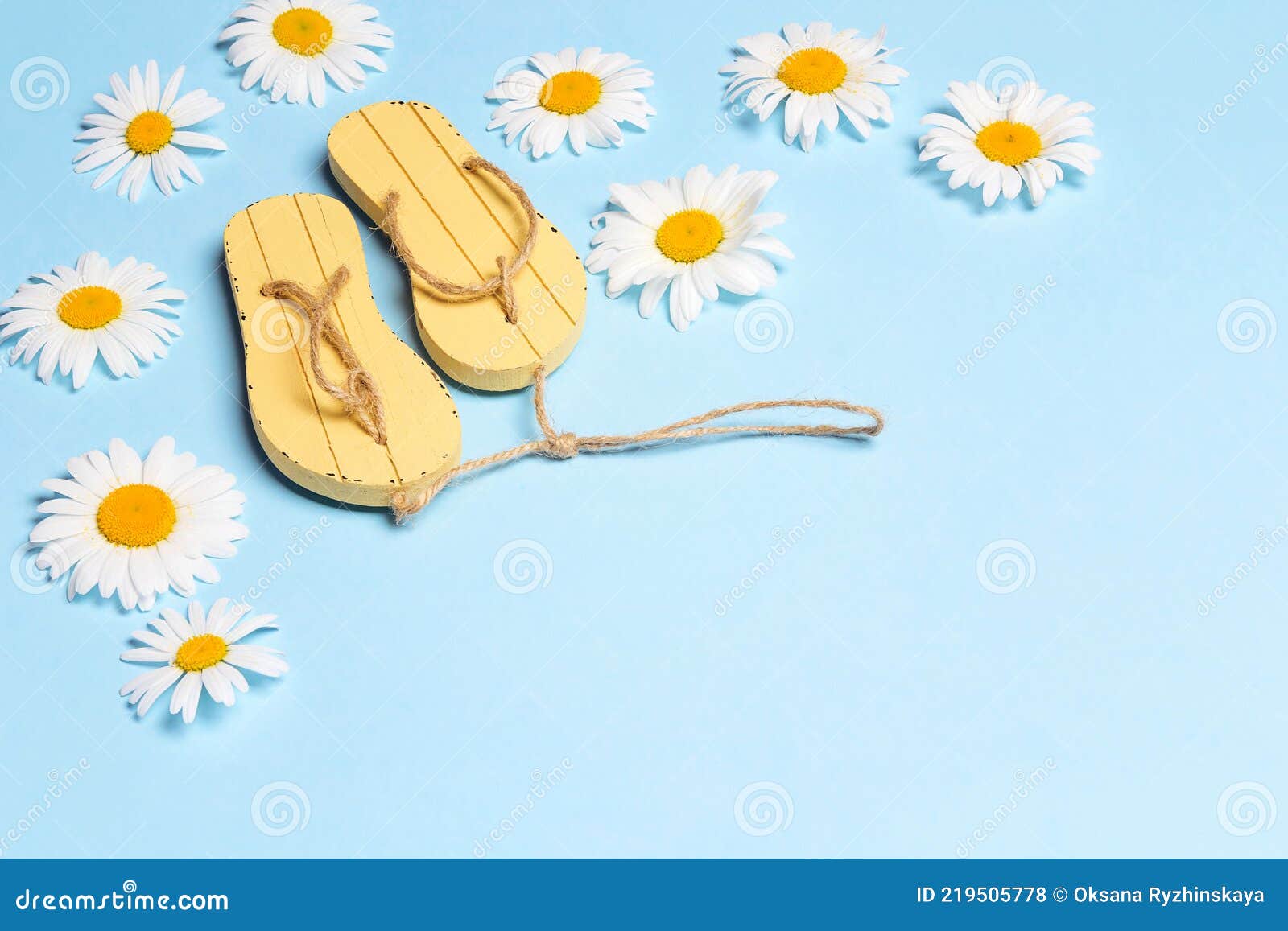 Yellow Flip-flops with Chamomile Flowers on Blue Background with Copy ...