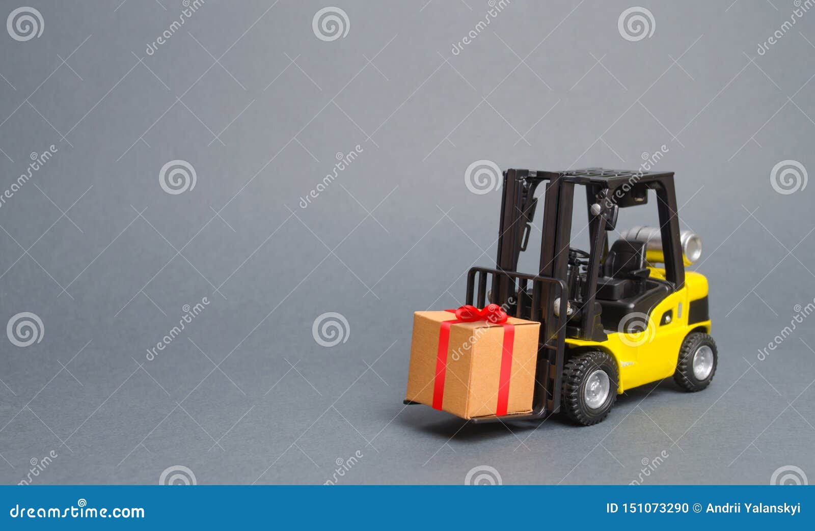 yellow forklift truck carries a gift with a red bow. purchase and delivery of a present. retail, discounts and contests