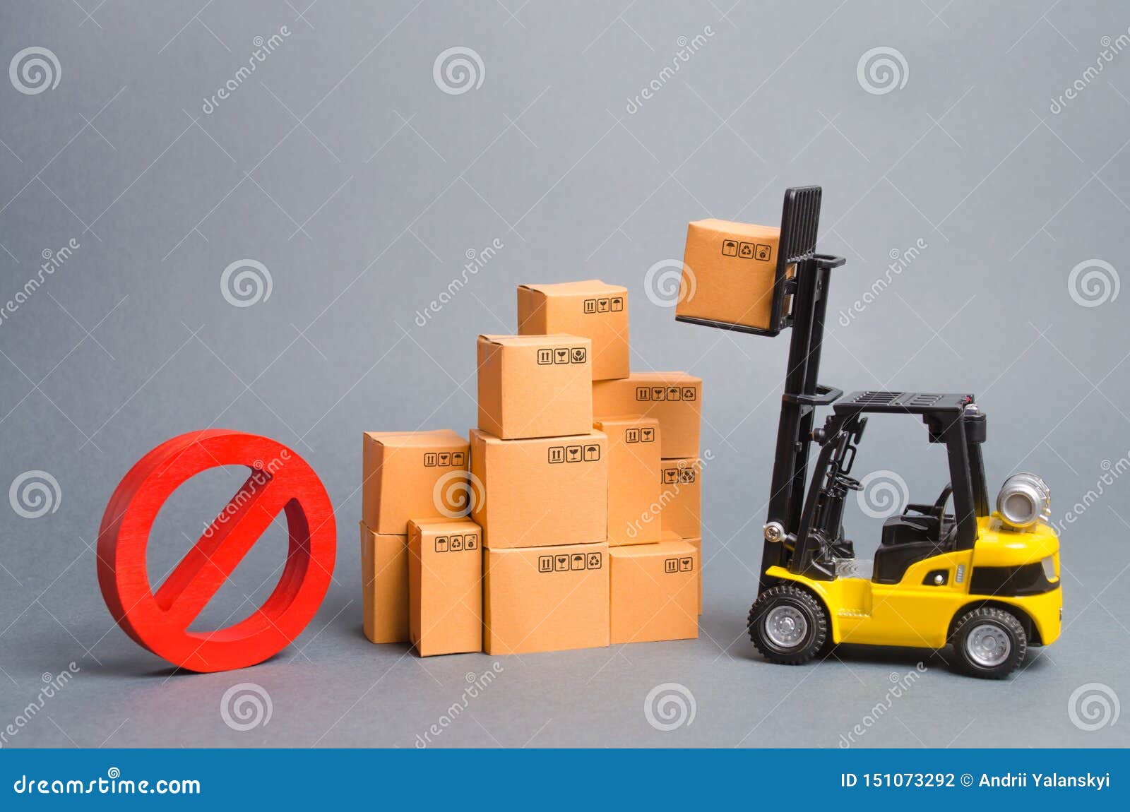 yellow forklift truck truckraises a box over a stack of boxes and a red  no. embargo trade wars. restriction on importation