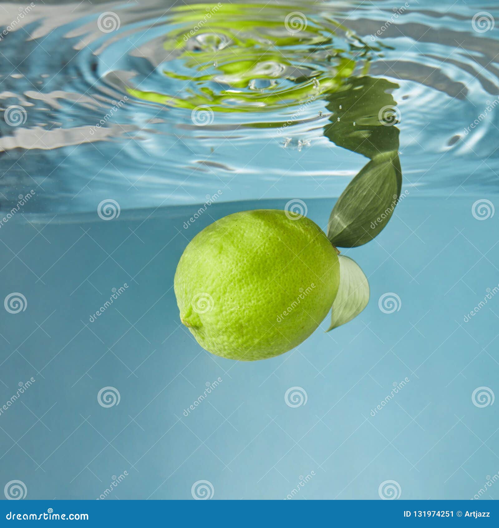 Yellow Fresh Lemon Falling Water with a Splash on a Blue Background ...