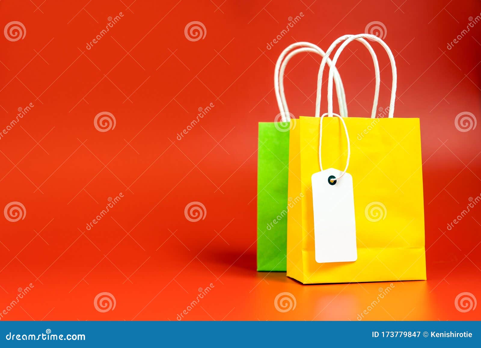 Yellow and Green Shopping or Gift Bags Isolated on Red Stock Image ...