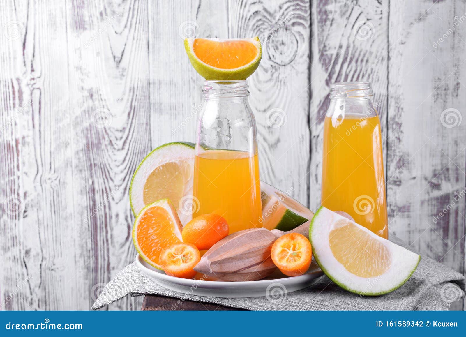 Download Yellow Juice In Glass Bottles And Pieces Of Citrus Fruits Stock Photo Image Of Drink Bottles 161589342 Yellowimages Mockups