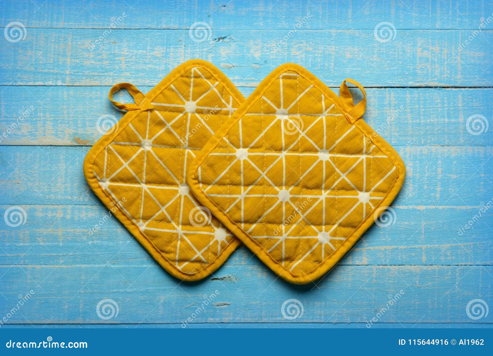 Yellow Kitchen Pot Holders on Blue Table Stock Photo Image of napkin