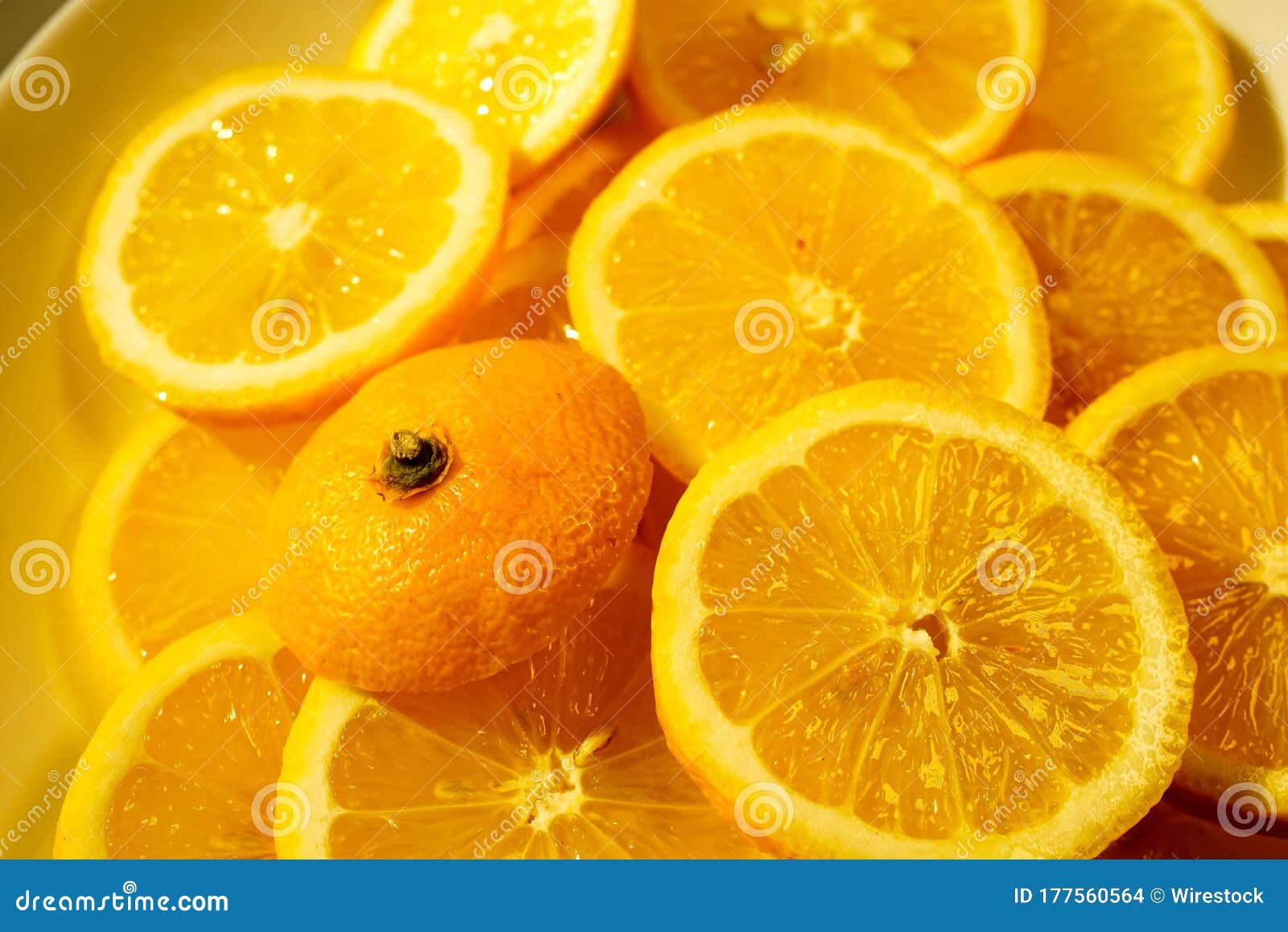 yellow lemons on a plate on a sunny day