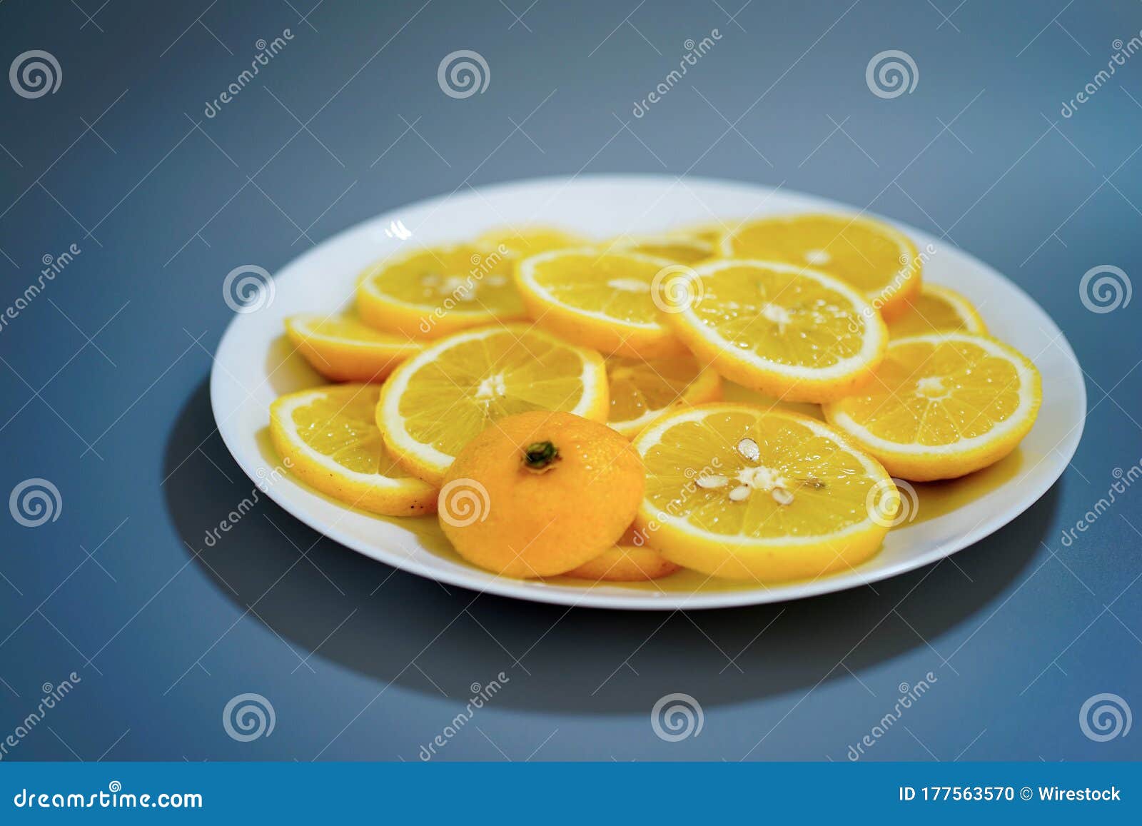 yellow lemons on a plate on a sunny day
