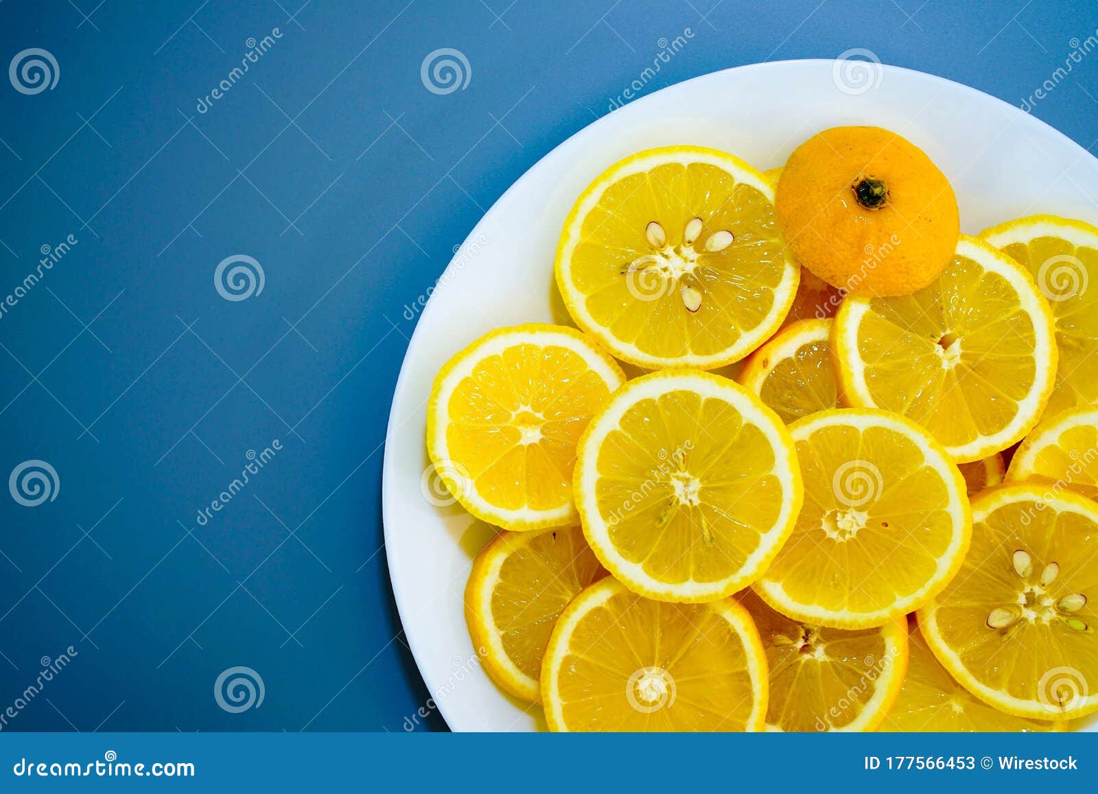 yellow lemons on a plate on a sunny day