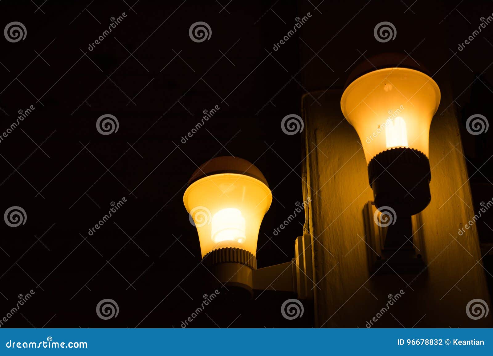 Yellow Light Bulb with Pole in Dark Room. Stock Photo Image of glow