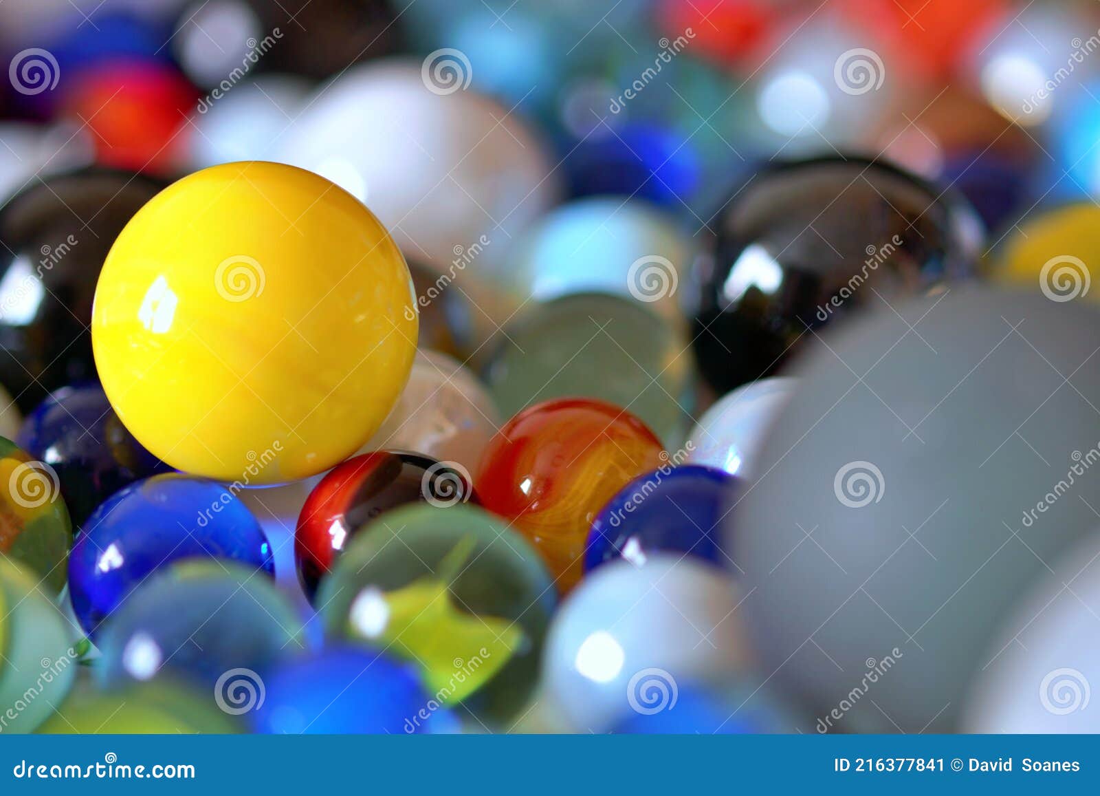 yellow marbles are so collectable and stand out when placed together - stock photo
