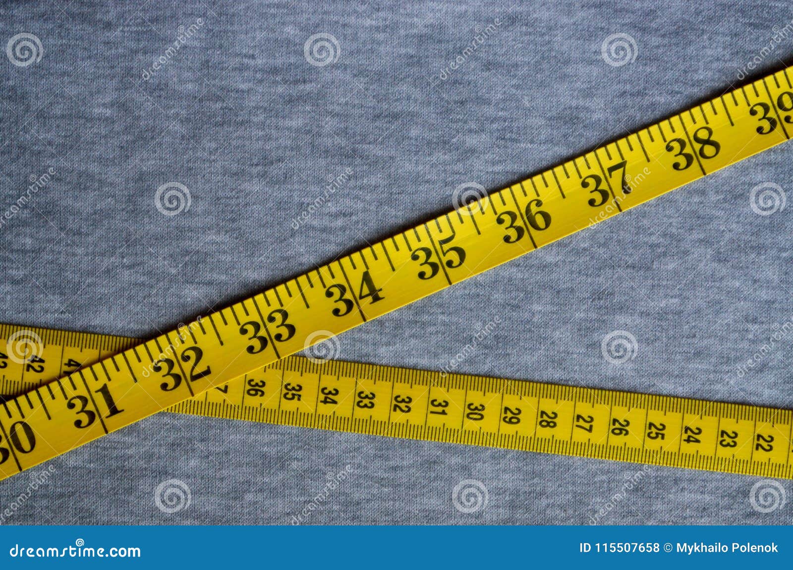 https://thumbs.dreamstime.com/z/yellow-measuring-tape-lies-gray-knitted-fabric-numerical-indicators-form-centimeters-inches-concept-115507658.jpg
