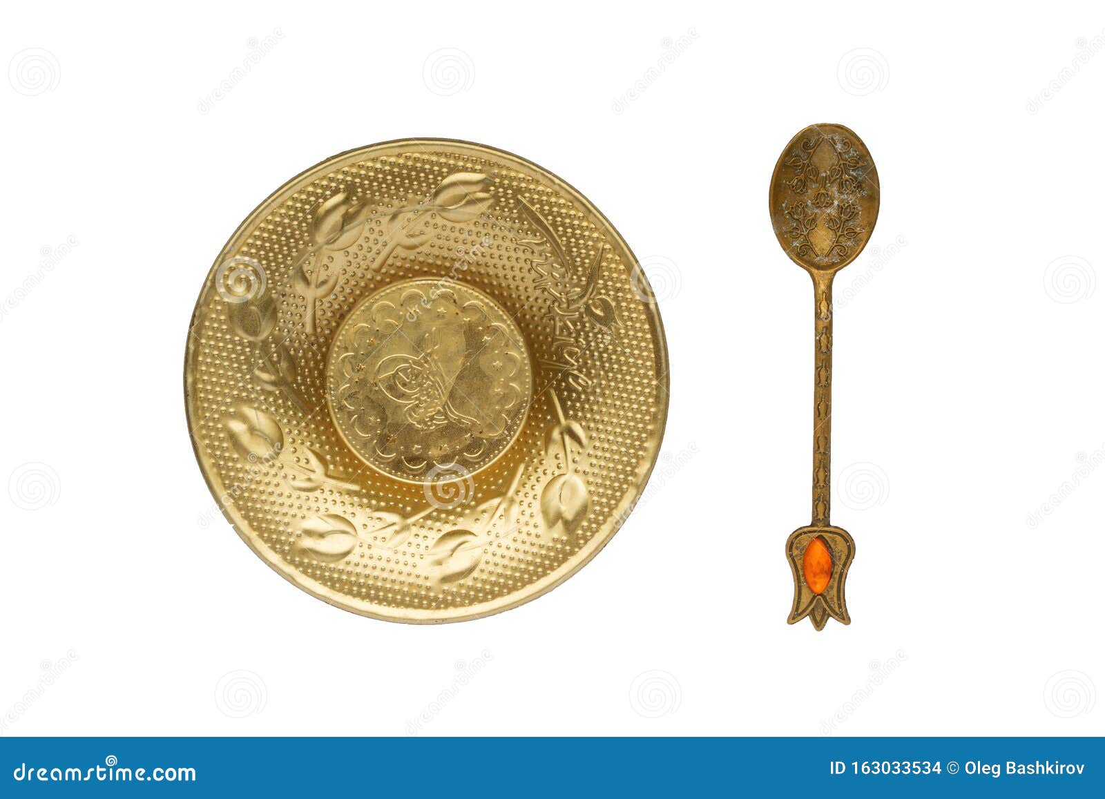 Yellow Metal Dish and Spoon with Arabic Style Decorations Stock Photo