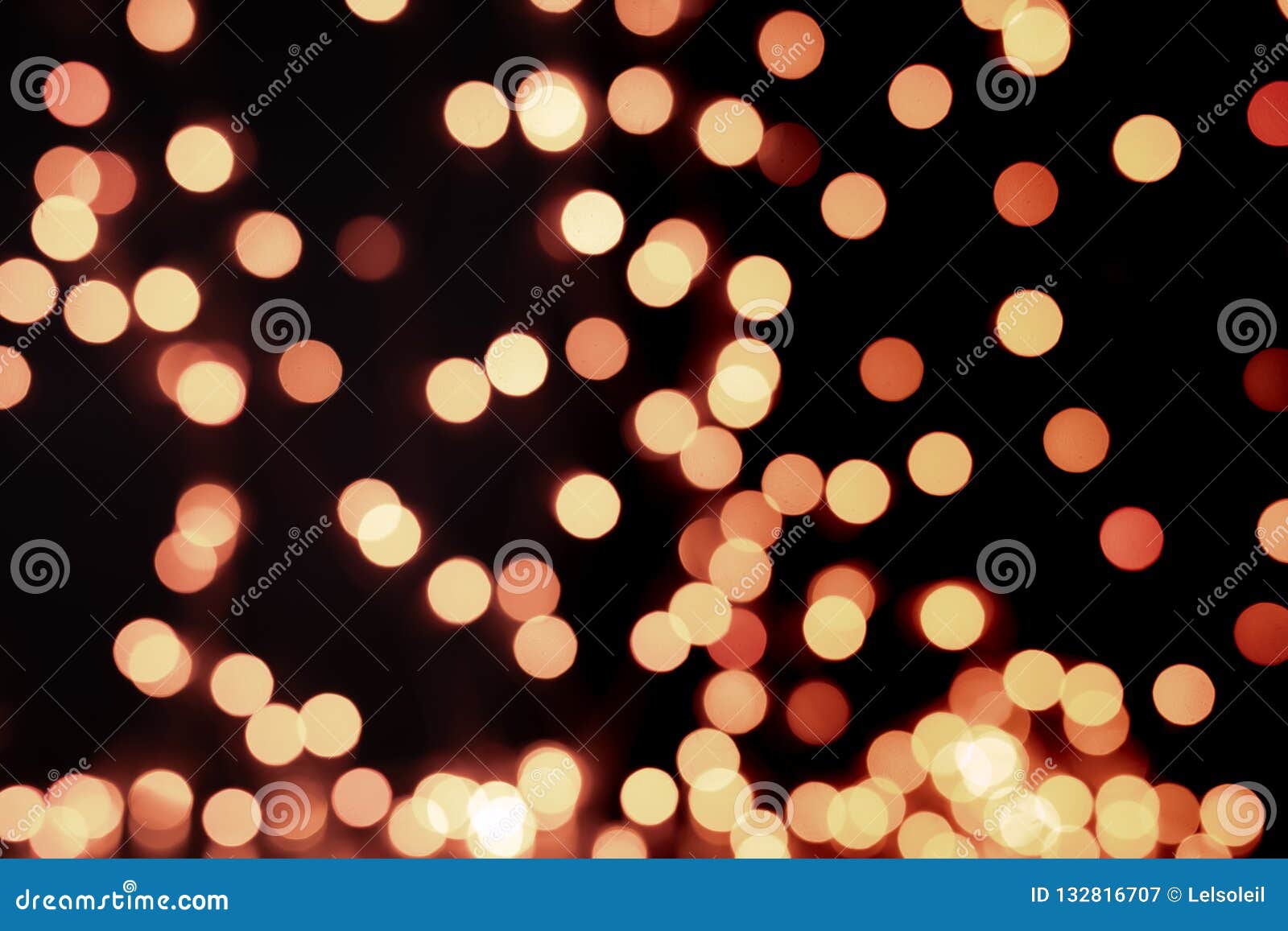 Yellow and Orange Christmas Tree Bokeh on Black Background of Defocused