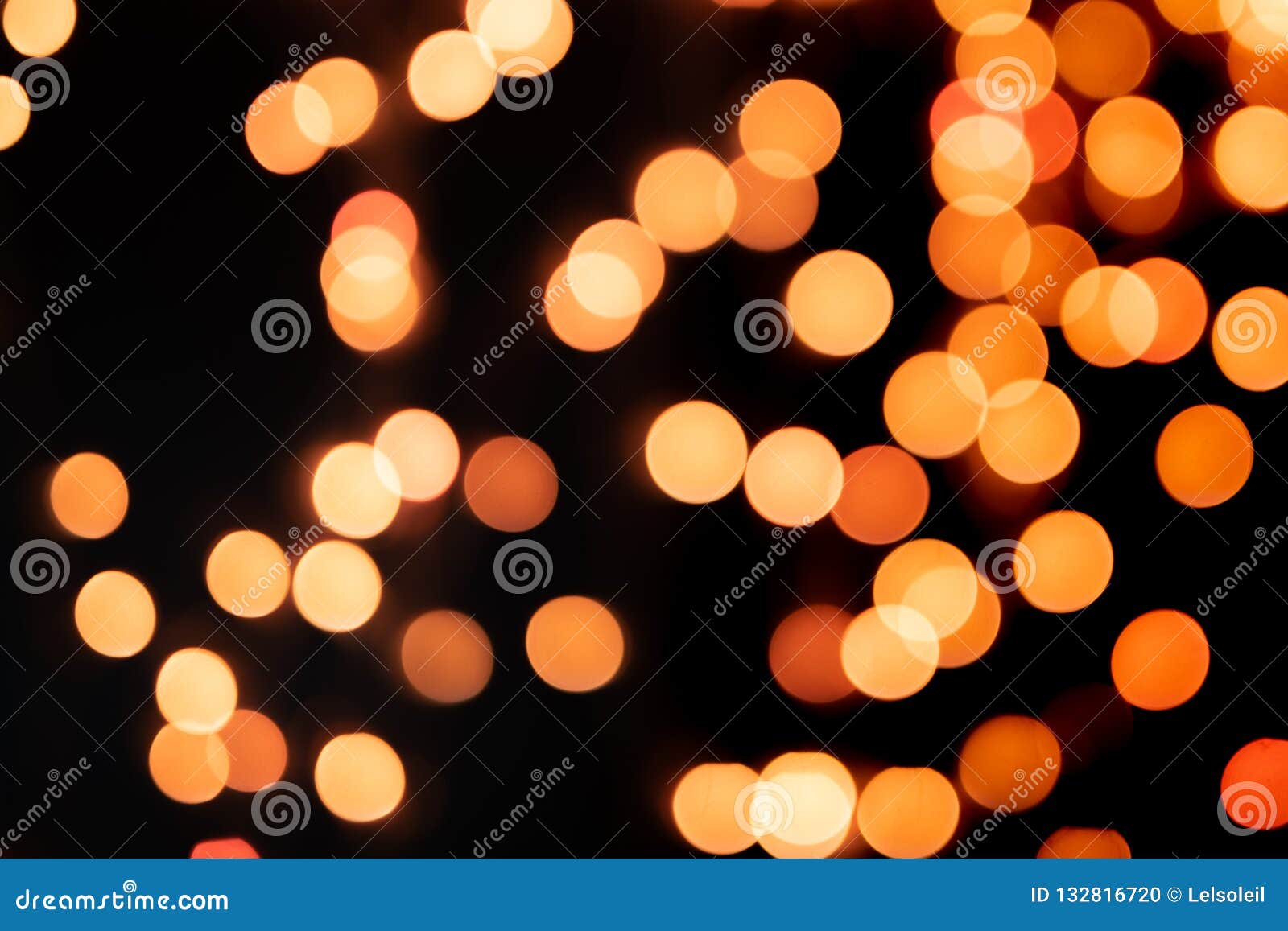 Yellow and Orange Christmas Tree Bokeh on Black Background of Defocused