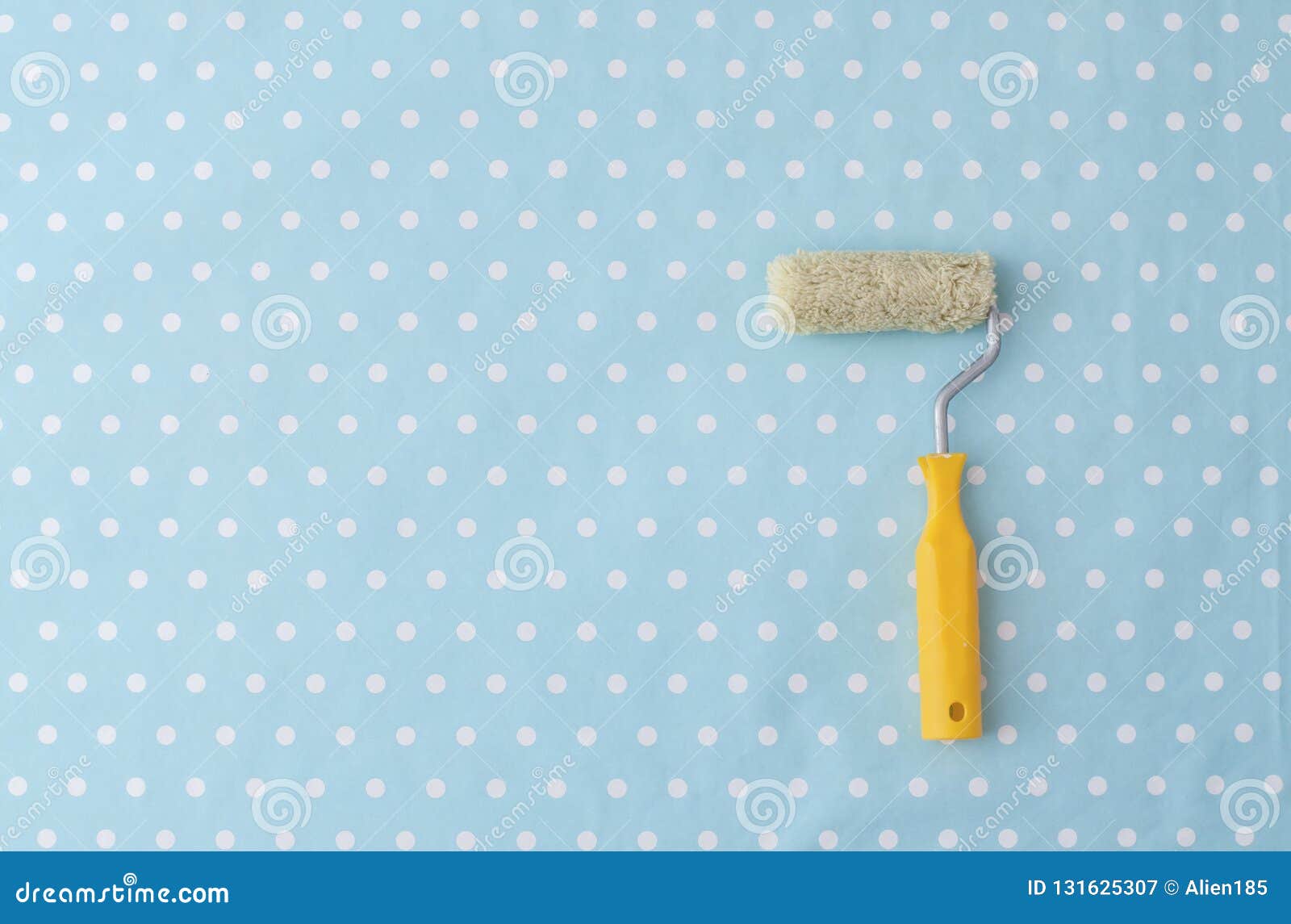 Yellow Paint Roller Over Blue Polka Dot Wallpaper Stock Image - Image of  wall, roll: 131625307