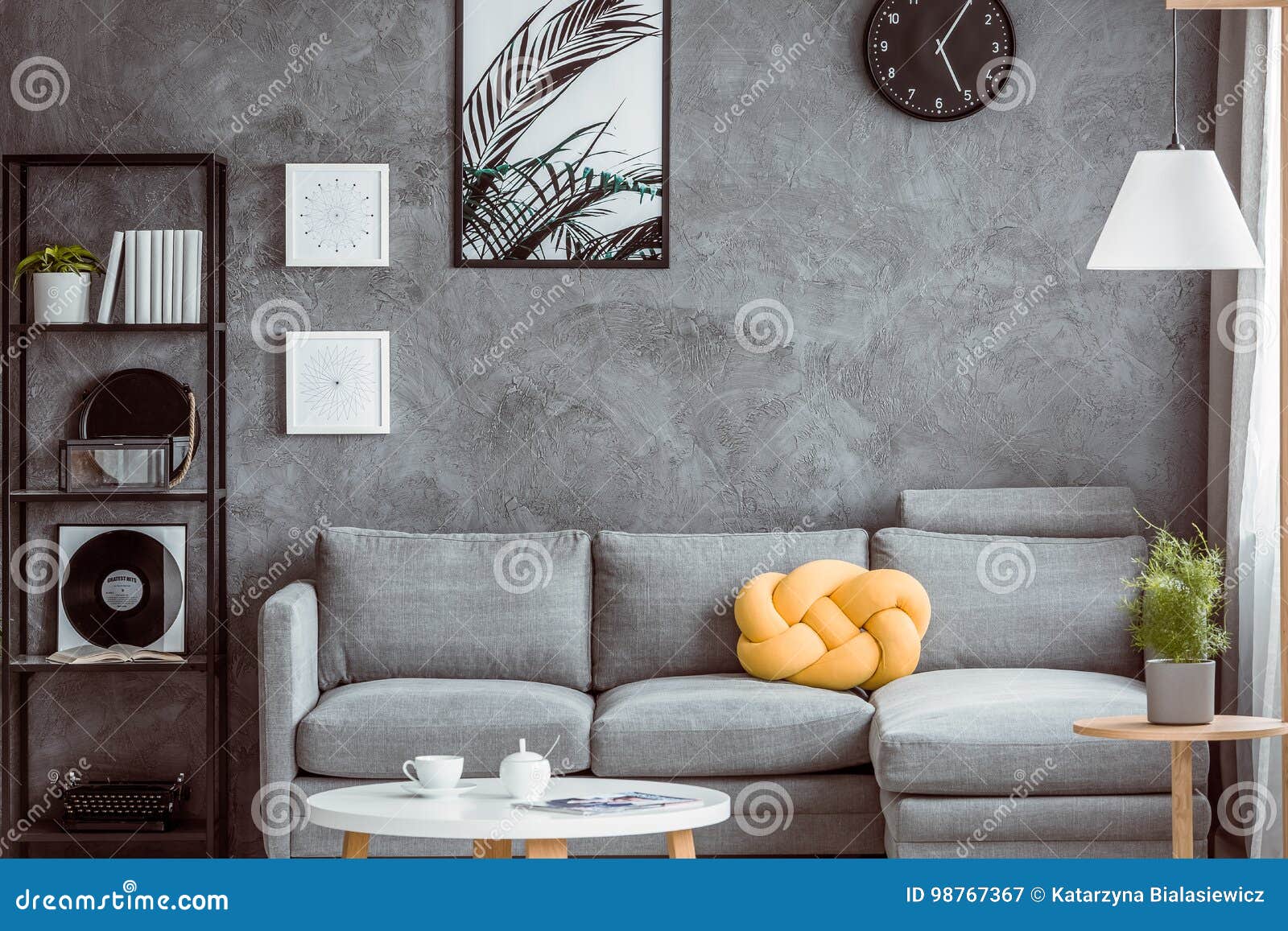 yellow pillow on grey settee