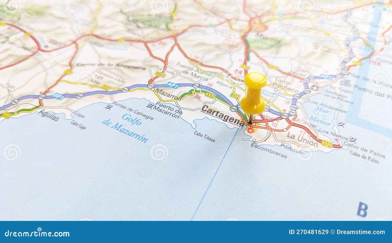a yellow pin stuck in cartagena on a map of spain