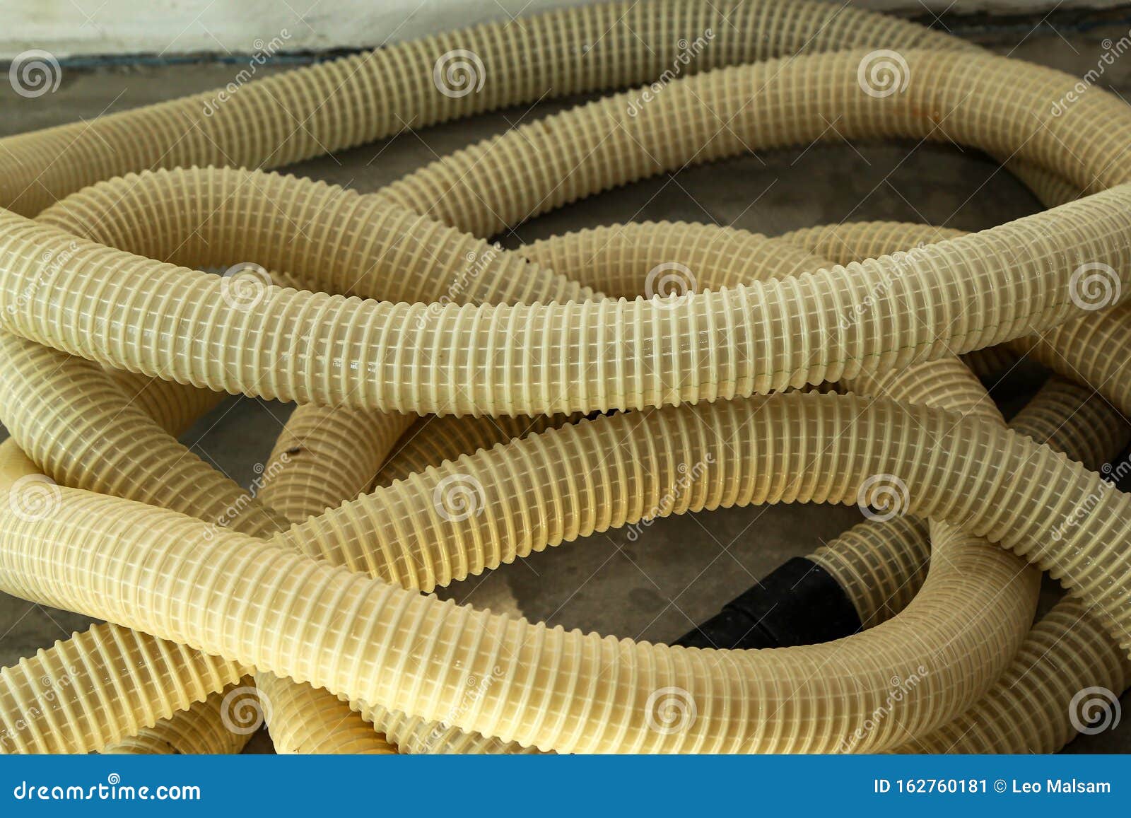 Yellow Plastic Corrugated Tubes for Water Supply, Rolled Up Stock Image
