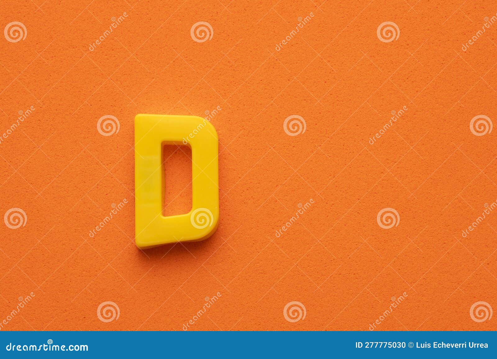 Yellow Plastic Letter D Uppercase on Orange Foamy Background Stock ...