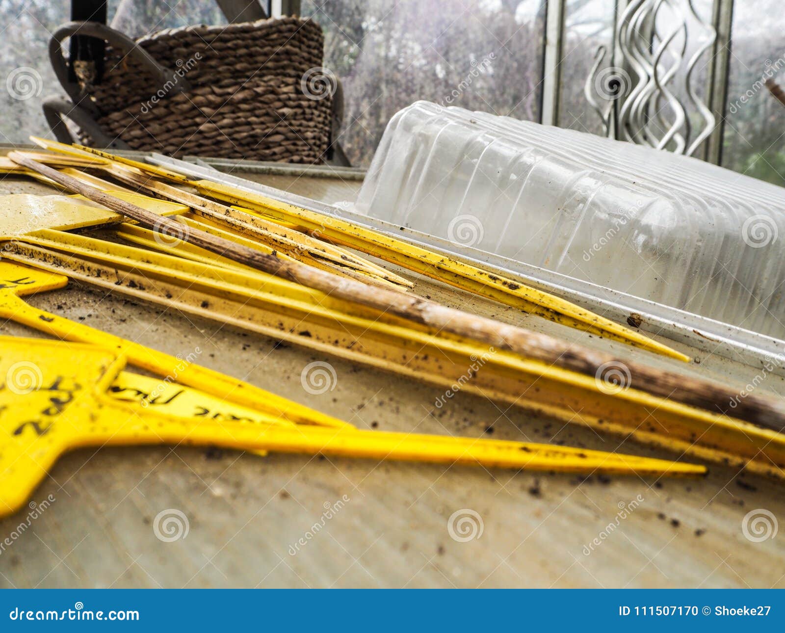 Yellow Plastic Tags with Vegetable Names Stacked on a Work Bench Stock
