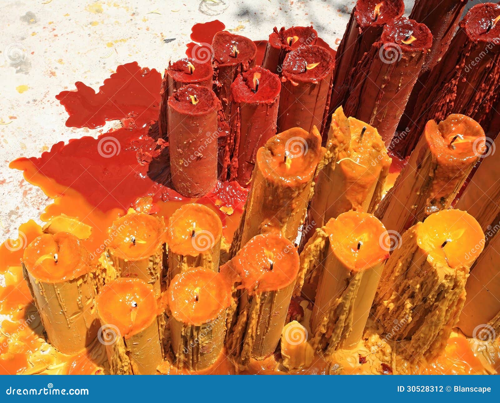 Yellow and red candles stock photo. Image of buddhism 30528312