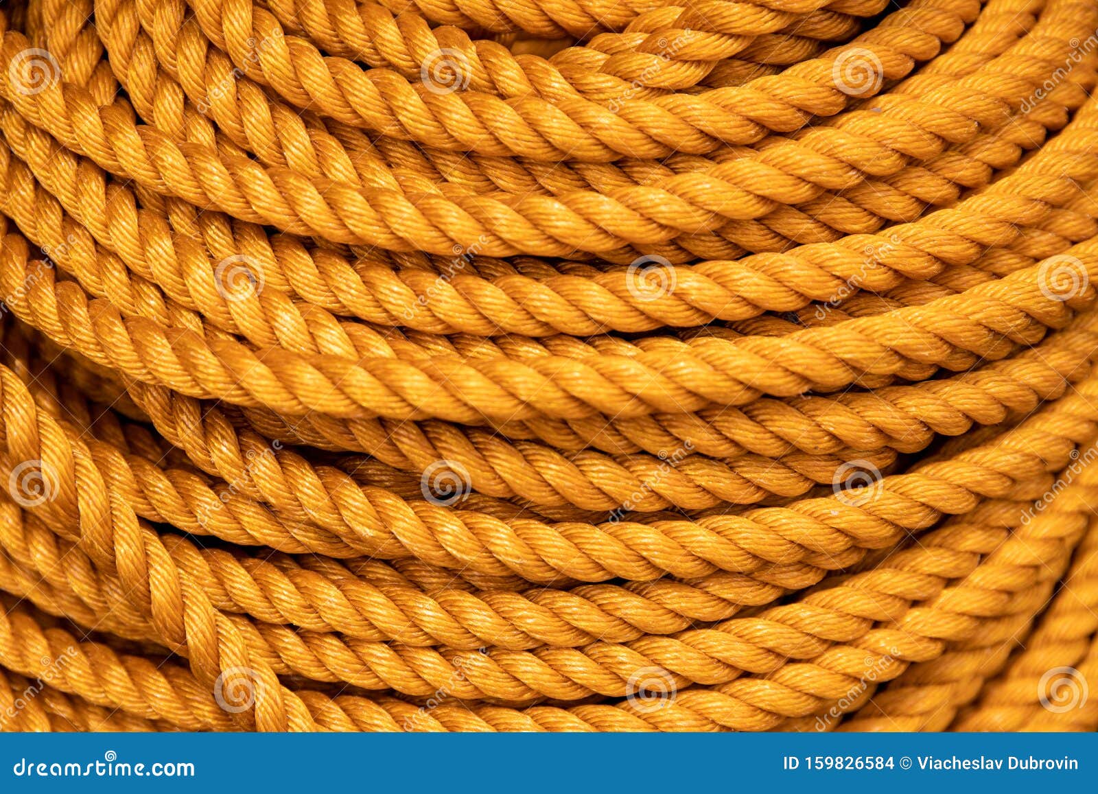 Yellow Rope Pile Closeup Photo. Ship or Rock Climbing Tackle