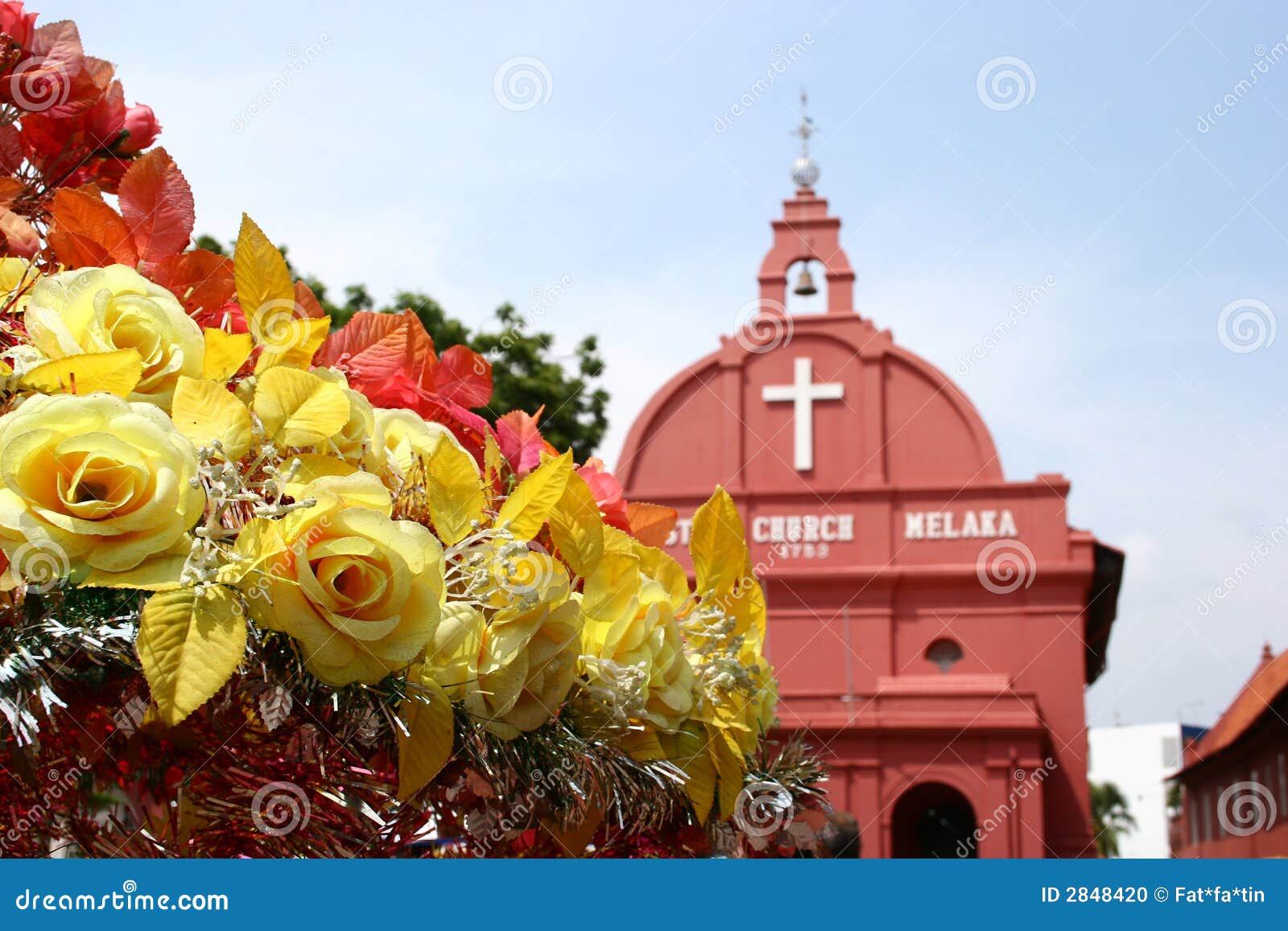 Yellow roses and red church background