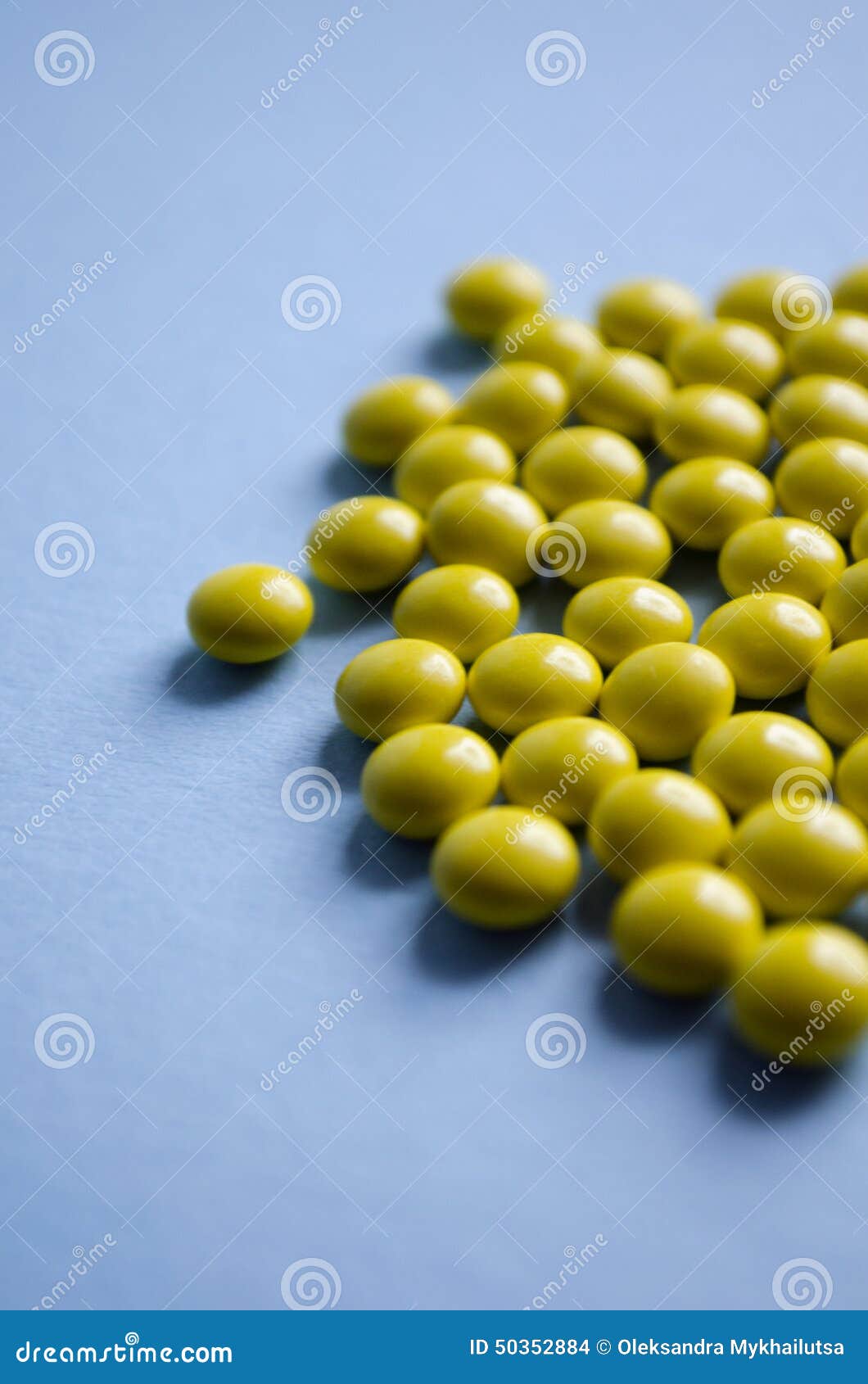 Yellow Round Pills on a Blue Background Stock Photo Image of