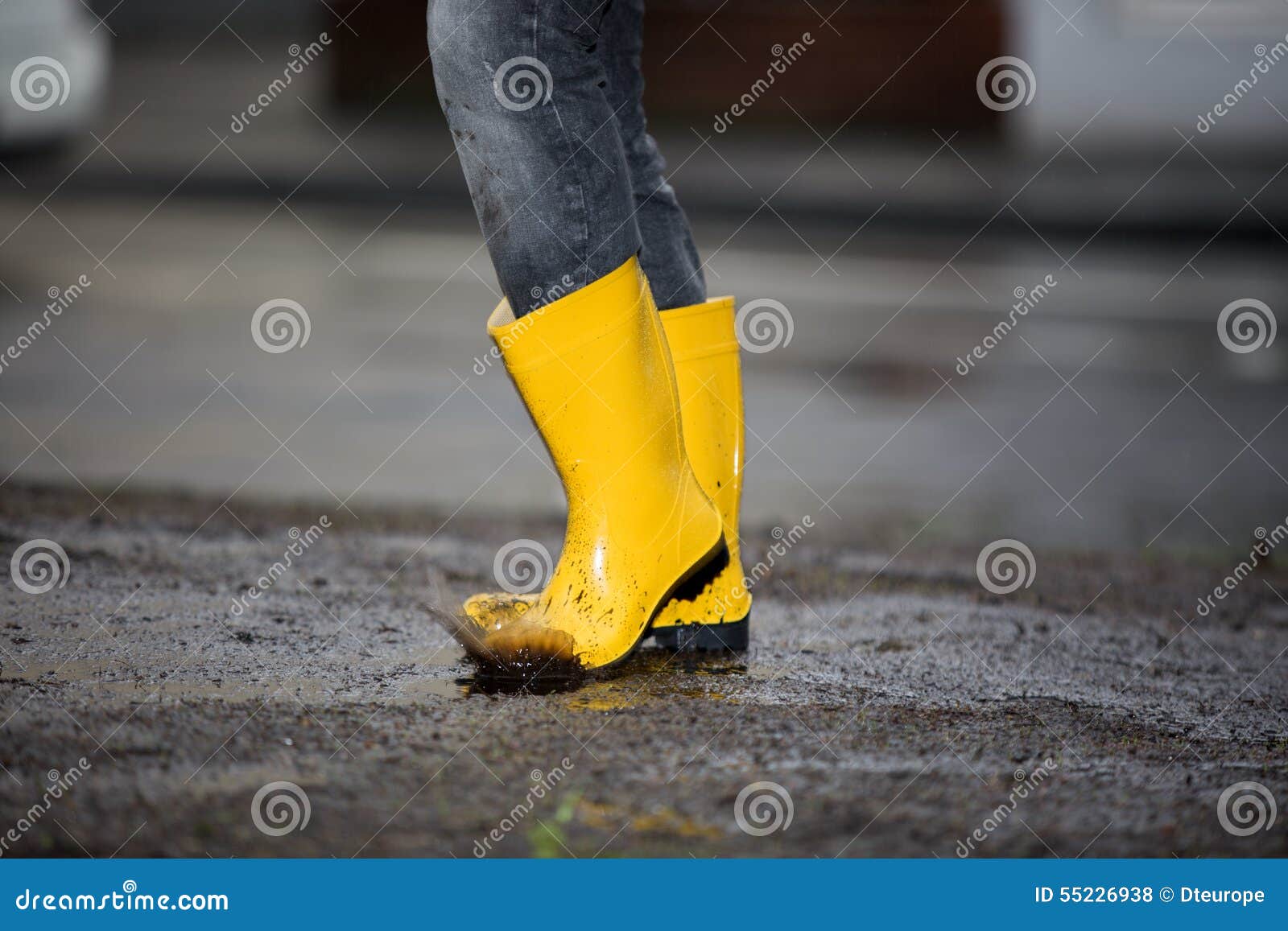 Yellow Rubber Boots in a Dirty Puddle Stock Photo Image of human