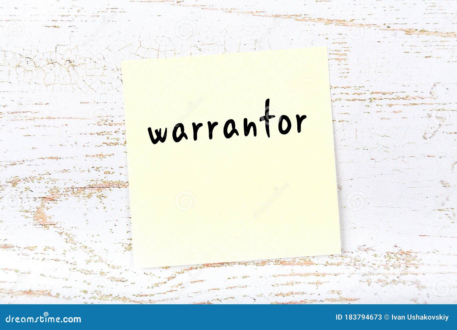 yellow sheet of paper with word warrantor. reminder concept