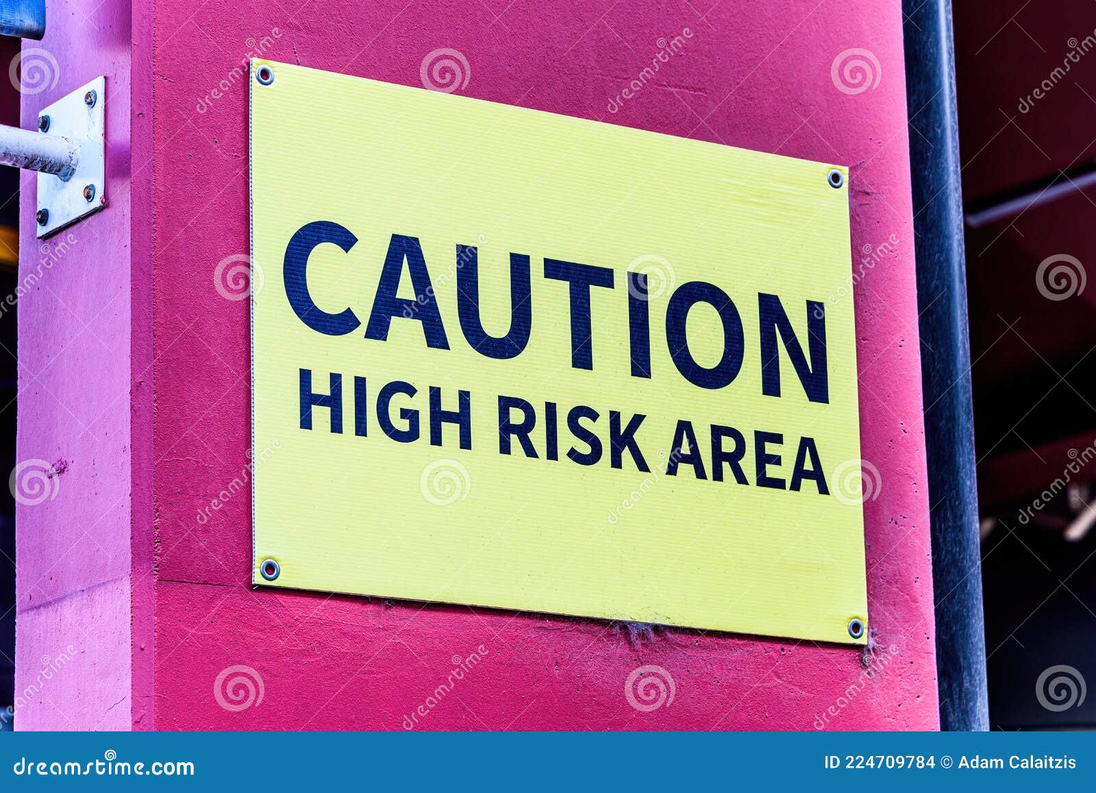 A Yellow Sign Displaying the Words: Caution, High Risk Area Stock Photo