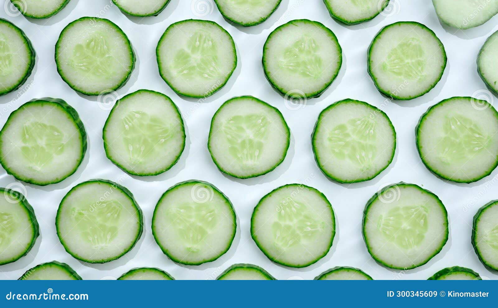 Yellow Sliced Cucumbers Places on a White Table. Background Texture of Fresh Green Fruit. Stock