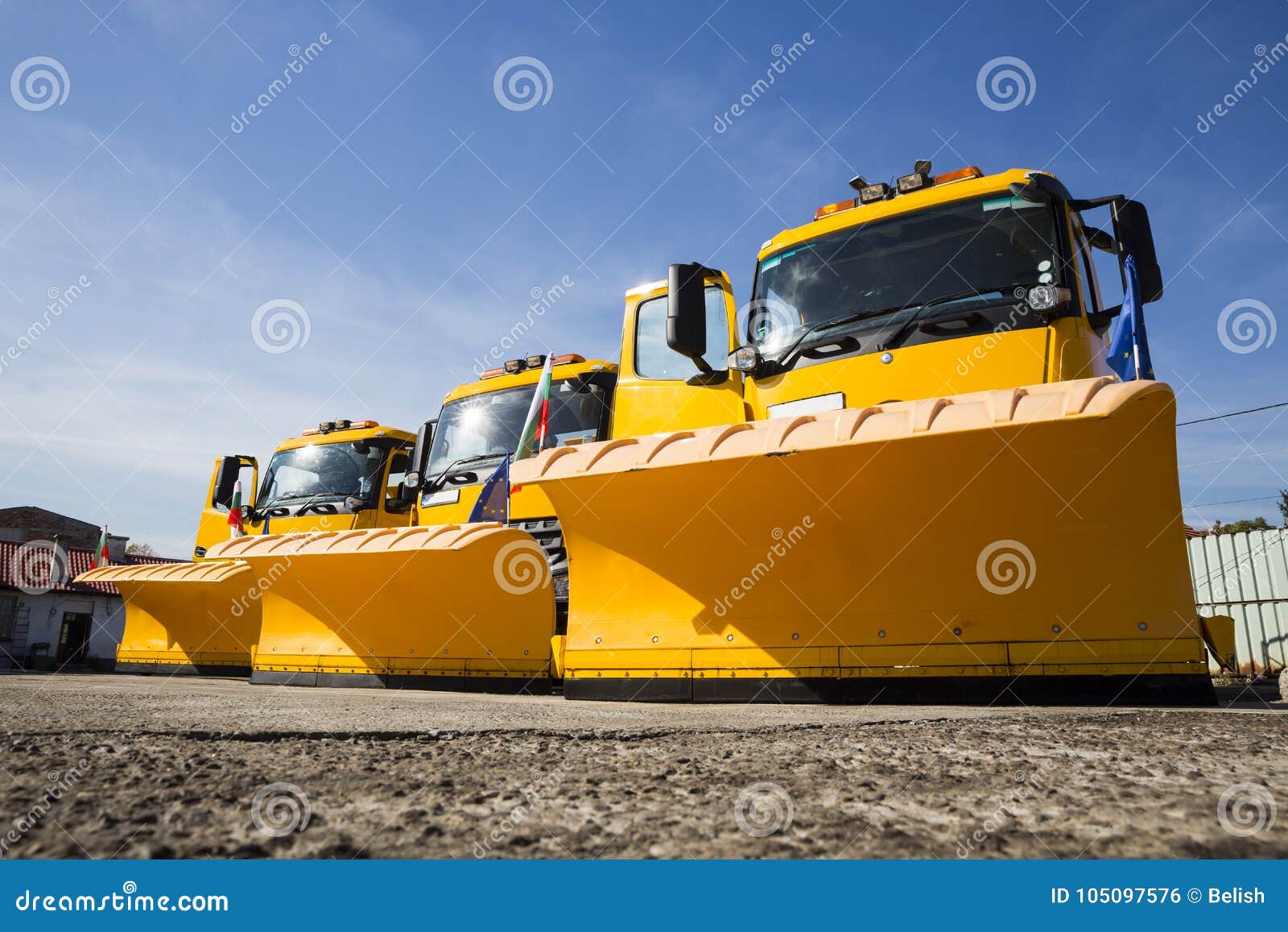 yellow snowplow trucks in line