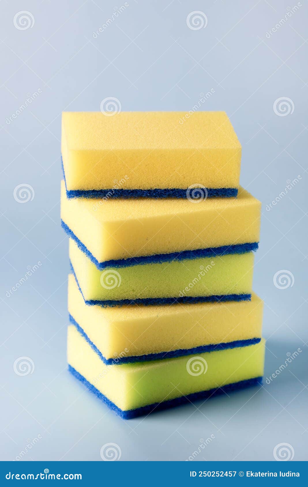 Yellow Sponges for Dishwashing on Blue Background Vertical Stock