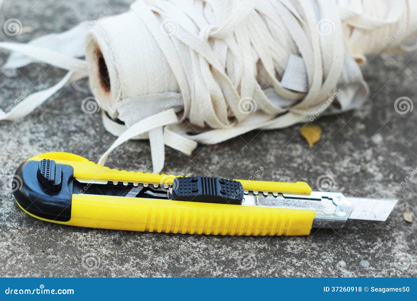 The Yellow Stationery Knife on a White Rope. Stock Photo Image of