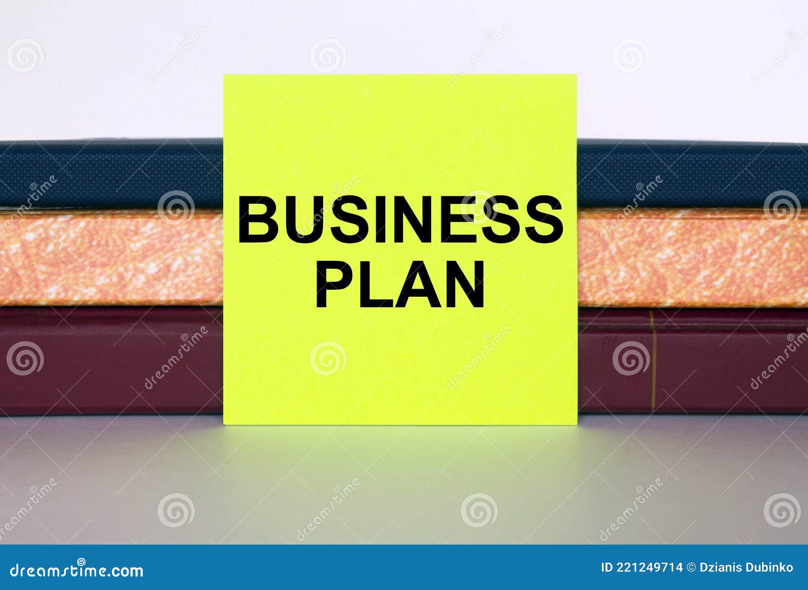 Yellow Sticker with Text Business Plan on a Stack of Notebooks Stock