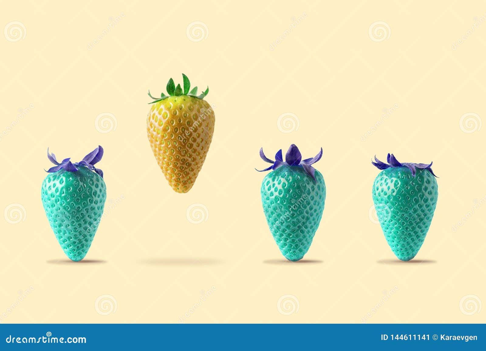 yellow strawberry floating with blue strawberry on bright background. minimal food concept