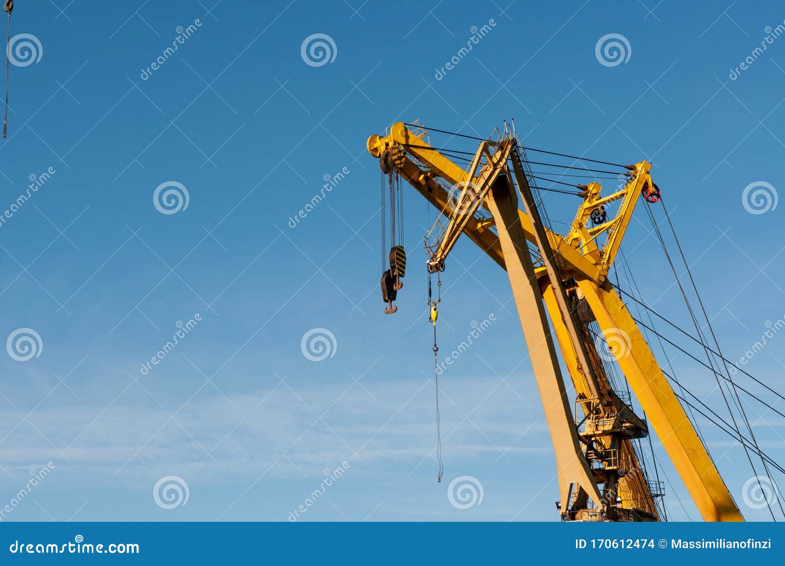 yellow tower crane with blue sky