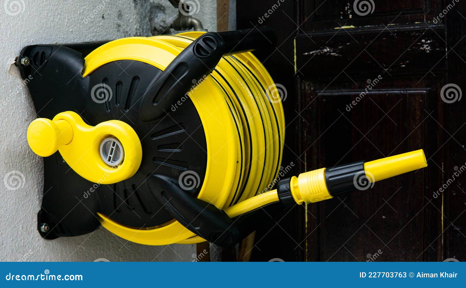 A Yellow Wall Mounted Garden Water Hose Reel with Sprinkler or