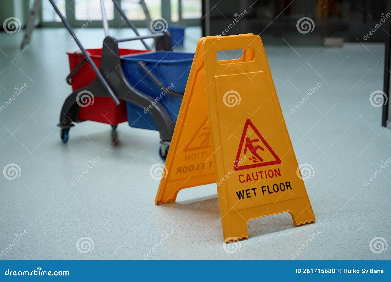 yellow warning sign about wet floor helping prevent tripping