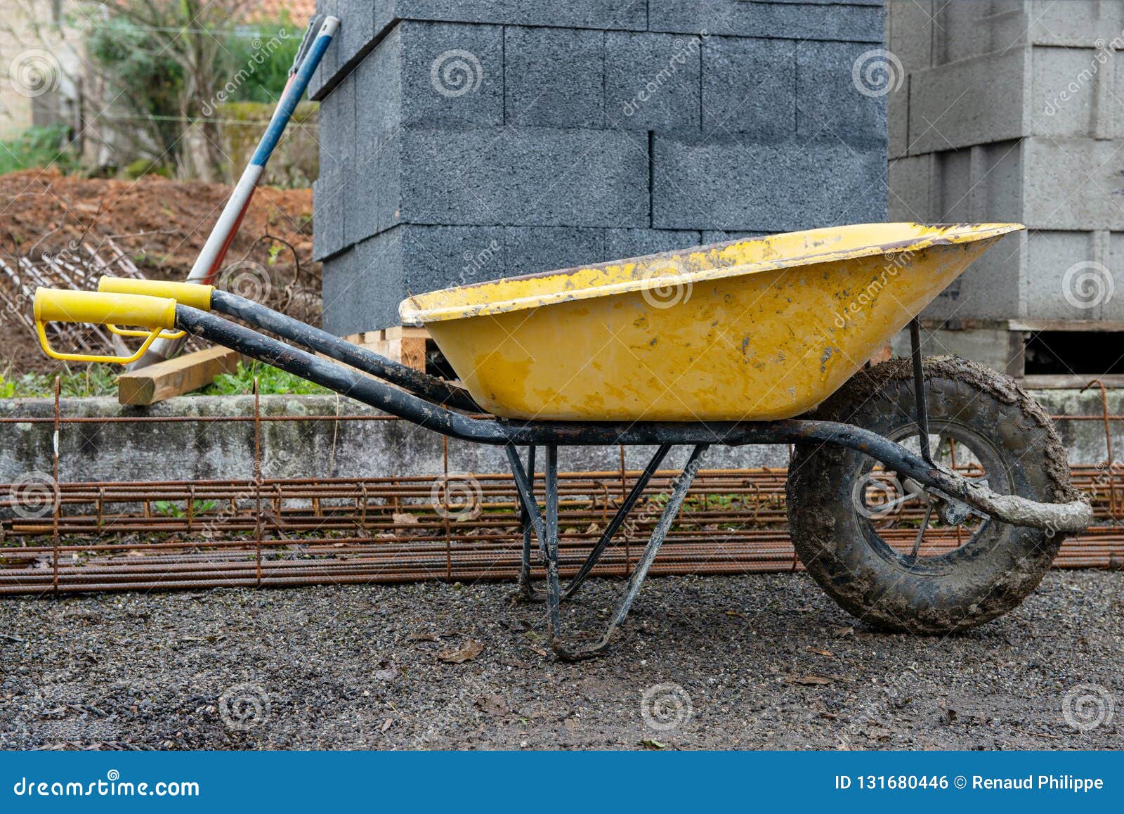 Yellow Wheelbarrow in Construction Site after Use Stock Photo Image