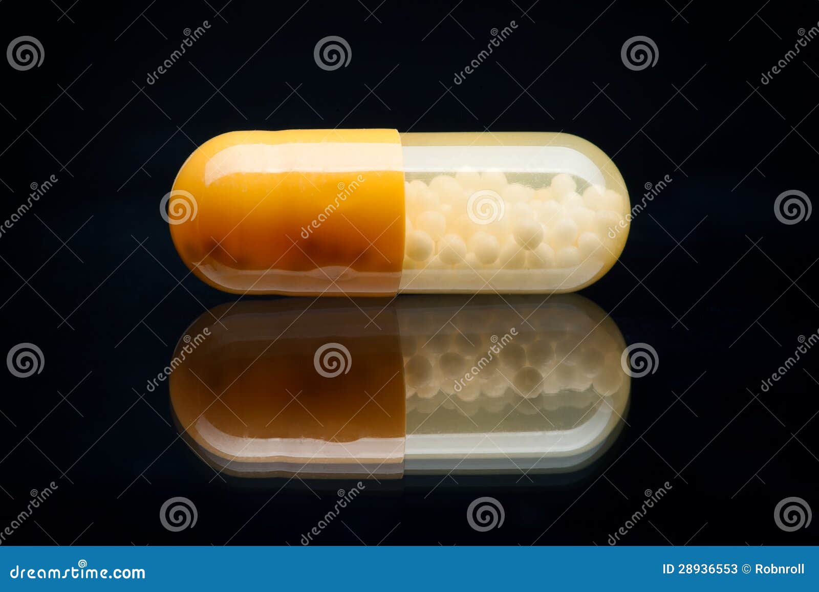Yellow and White Pill (capsule) Macro Shot, Isolated on Black Stock