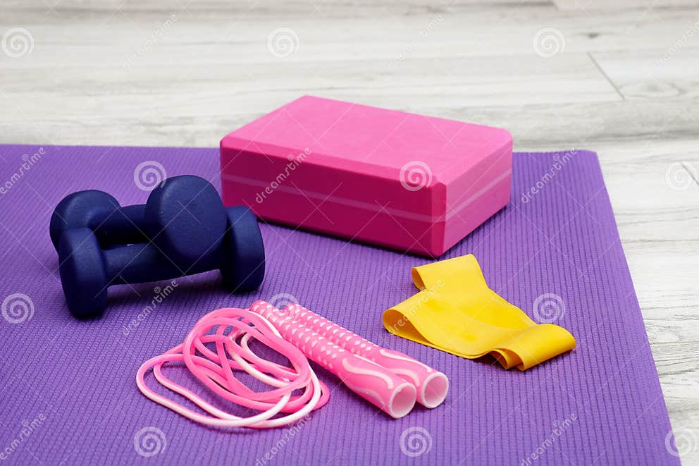 Yoga Brick and Jump Rope on Purple Gym Mat Stock Photo - Image of ...