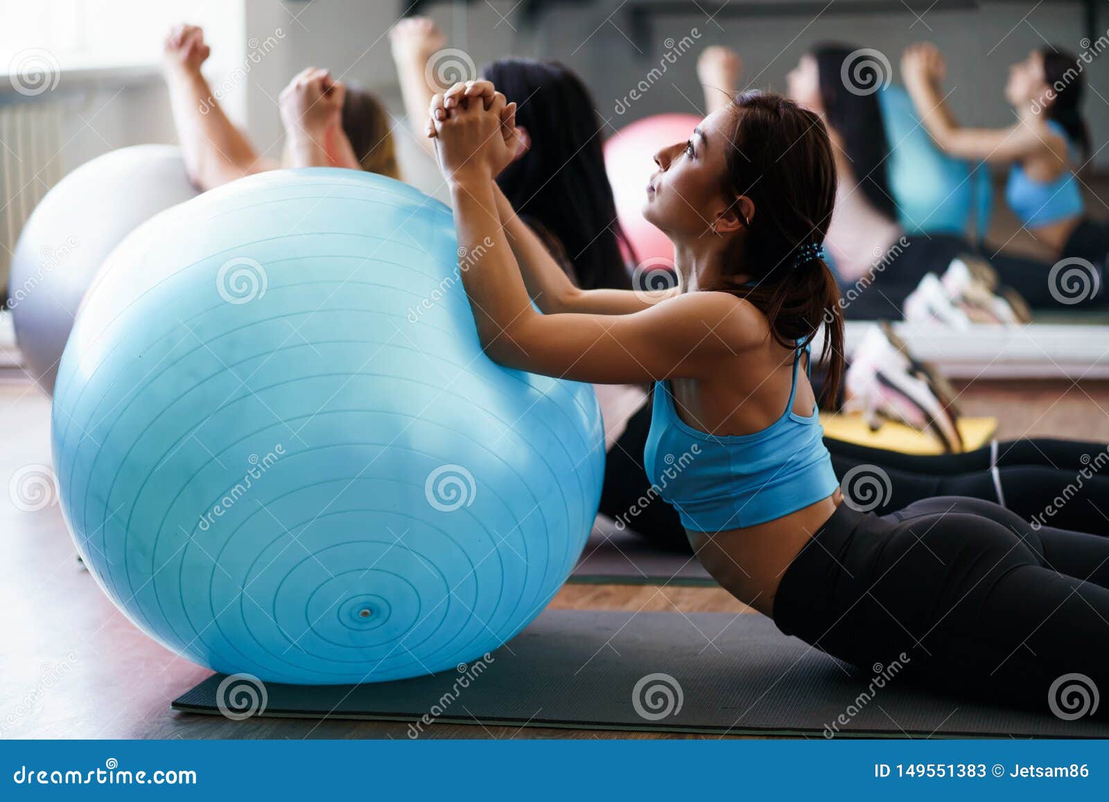 Women Doing Stretching Exercises on Sporting Balls Stock Image