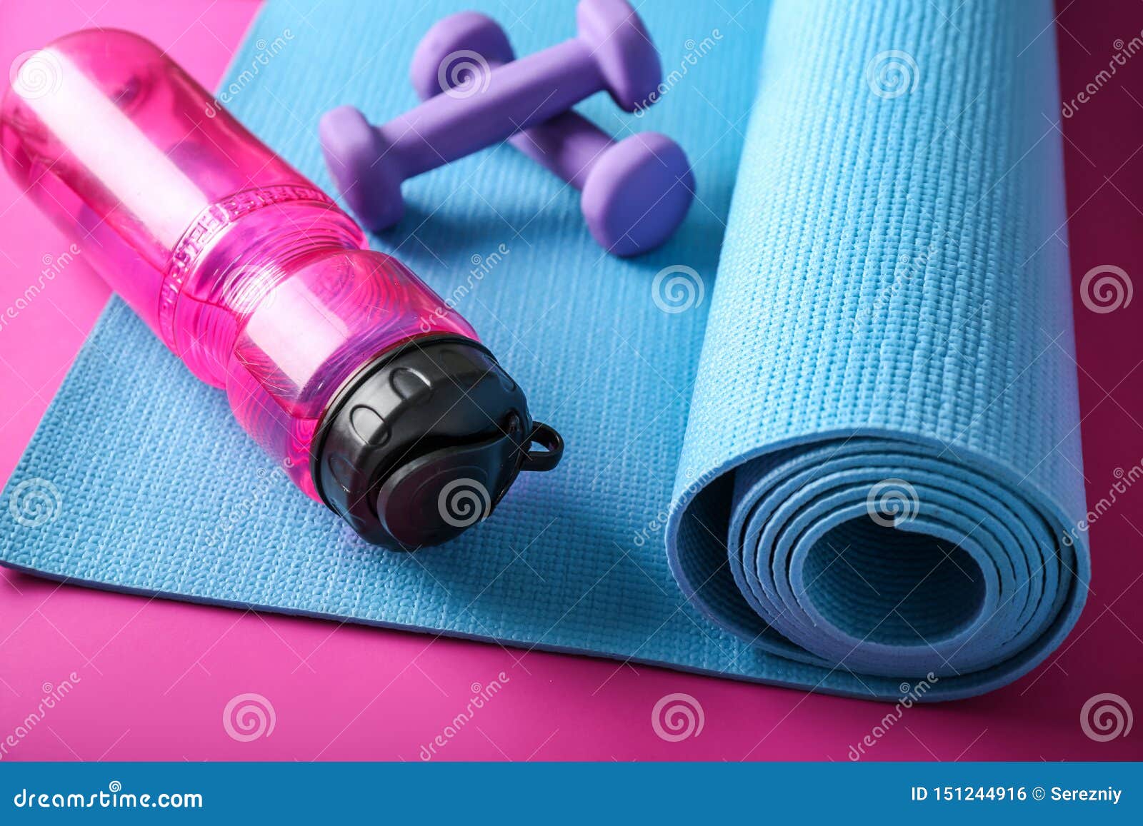 Yoga Mat, Dumbbells and Bottle of Water on Color Background Stock Photo ...