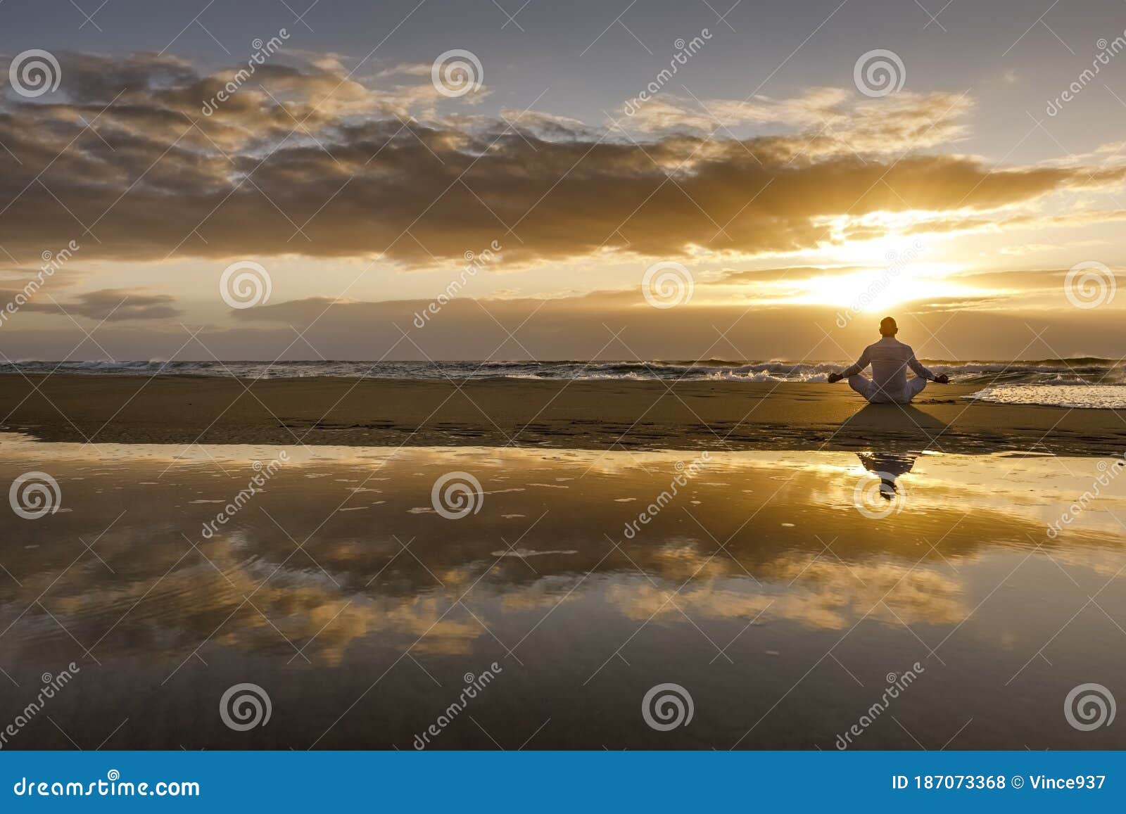 yoga meditation silhouette lotus sunrise beach, water reflection of man in yoga pose, mindfulness wellbeing concept