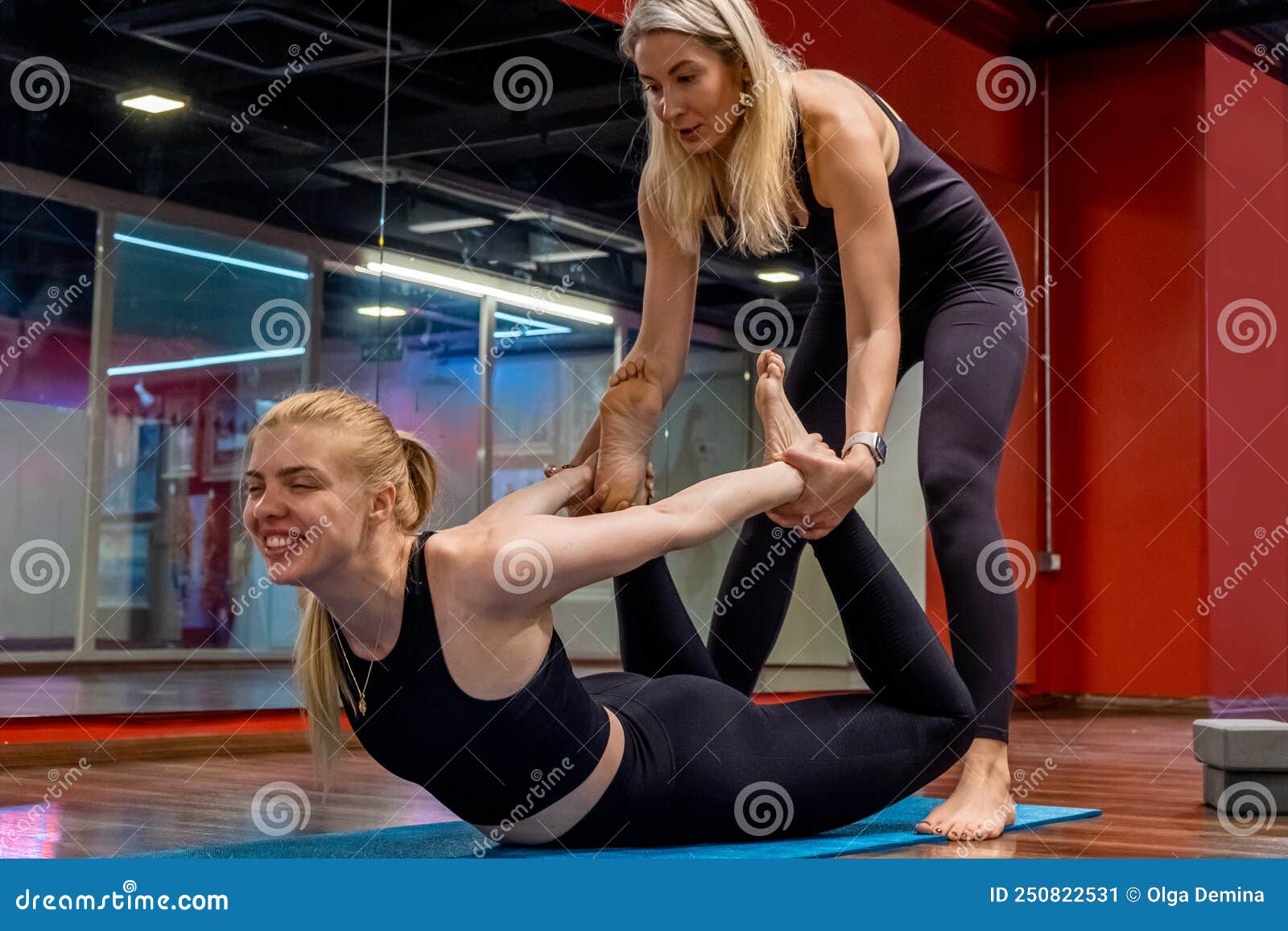 Yoga Teacher Help Student while Practicing Yoga Teaching Correcting